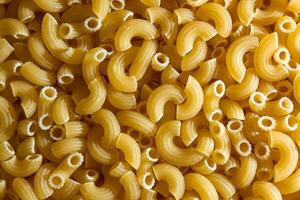 Uncooked Chifferi Rigati Pasta. A Culinary Canvas of Chifferi Rigati, Creating a Lively and Textured Background for Gourmet Cooking. Dry Pasta. Raw Macaroni - Top View, Flat Lay photo