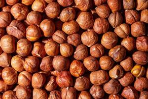 Scattered Peeled Hazelnut - Top View. Background from Hazelnuts. Natural High-Calorie Snacks photo
