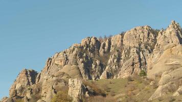 Rocky cliffs in high mountains with blue sky. Shot. Marvelous view of grey mountain landscape video