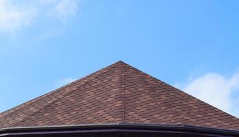 Decorative metal tile on a roof. Types of a roof of roofs photo