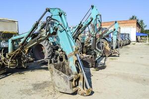 Tractor with a bucket for digging soil. Bulldozer and grader. photo