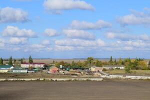 A view from above of a small Russian village. Rural landscape. Field and village. A semi-abandoned village. photo