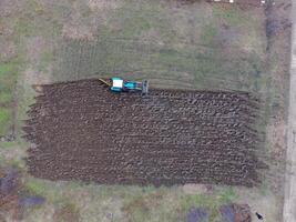 Tractor plowing the garden. Plowing the soil in the garden photo