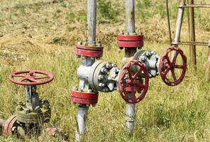 Manual shut-off valve on oil well. Oil well wellhead equipment. photo