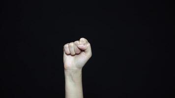 Close-up of hand with fist. Isolated on ablack background. video