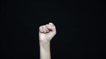 Close-up of hand with fist. Isolated on ablack background. video