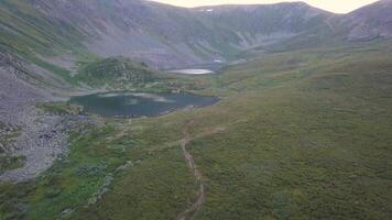 Lush beautiful green valley and cliffs aerial view. Clip. Flying over steep hills towards the mountains video