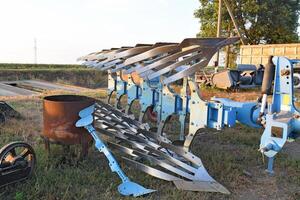 Rotary plow parked farm machinery photo