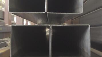 Stacked steel pipe with sunlight reflecting on the interior walls of central part. Rectangular metal pipe for construction. Pipes rectangular section. video