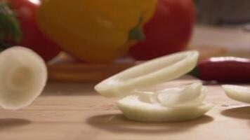 Close-up - Beautiful Onion Rings Falling While Cooking In A Restaurant Kitchen. Scene. Slices of onion close-up video