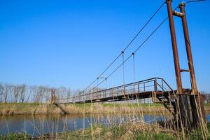 Steel bridge and gas pipeline through irrigation canal. photo