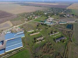 Top view of the village. One can see the roofs of the houses and gardens. Top view of the village with houses and hangars for the storage of grain. photo