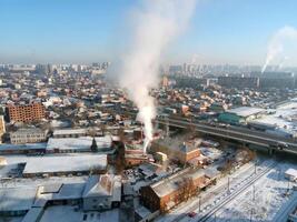 Winter town. Frosty sunny day in the city. Snow on the streets and smoke from the boiler rises. Frost and sun, a wonderful day photo