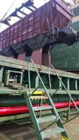 The precipitation of grain from the car into the hold of the tanker. Grain filling of the cargo compartment of the ship. photo