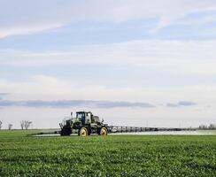 Tractor with a spray device for finely dispersed fertilizer. photo