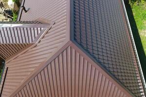 A view from above on the roof of the house. The roof of corrugated sheet. Roofing of metal profile wavy shape photo