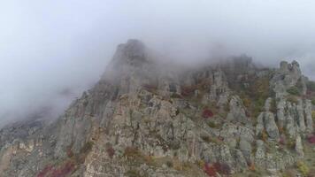 Top of the mountains in fog. Shot. Colorful view from the bottom video
