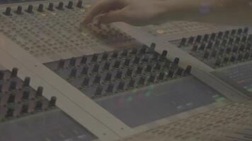 Sound mixer in action, hand. Sound engineering in studio. Hand on a mixer, operating the leader video