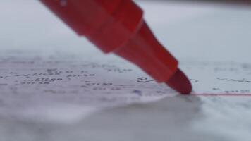 A red marker writes on a sheet of paper. Close-up. Marker Tip. Red marker with shadow video