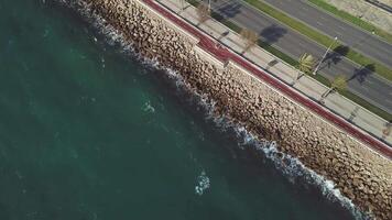 Aerial flying shot following cars on the highway alongside a rocky coast. Stock. Aerial view of Coastline along and highway video