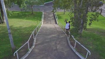 aggressiv in der Reihe Walze Klinger schleifen auf Schiene im Skatepark außen. Clip. Sommer- extrem Sport ausüben draussen im Schlittschuh Park. verschiedene Tricks video