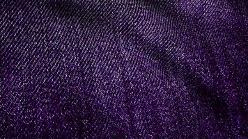 Denim fabric textured violet fluttering. Animated movement of the canvas. The waves of the material video