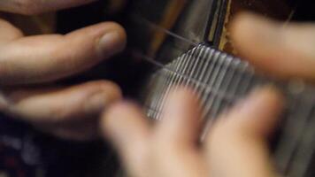 Man is playing a balalaika, close-up. Folk musical instrument balalaika. Game is on the strings video