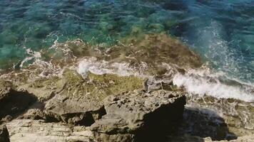 Man stands on the edge of the abyss and looks at the sea. Stock. Man traveler looking for adventure video