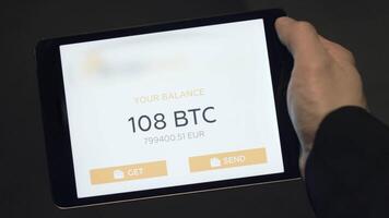 Tablet application showing the balance of a Bitcoin wallet. Stock. Digital currency concept. Balance of bitcoins on the tablet video