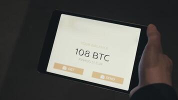 Tablet application showing the balance of a Bitcoin wallet. Stock. Digital currency concept. Balance of bitcoins on the tablet video