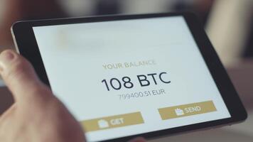 Mann prüft das Konto auf das Tablette. Aktie. Überprüfung das Bitcoin Balance auf das Konto video