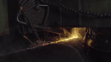 Welder complete with personal protective equipment is perform pipe welding in dark area using Automatic Welding System. Welding sparks spreading everywhere. Automat welding pipe production video