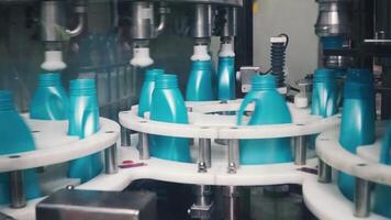 Liquid detergent on automated production line. Clip. Automated production line of washing fluid. Machinery for bottling video