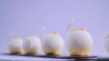 Velvet cake balls with sugar sprinkles. White, ball-shaped cakes. Decorative white cakes video