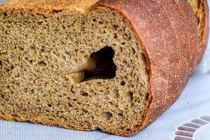 Rye bread with a large hole in the cut. photo