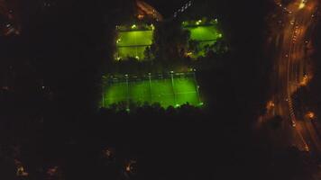 Footbal soccer field night aerial. Clip. Long exposure birds eye view of green footbal court. Top view of the football field at night video