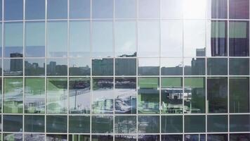 Office building windows background. Buildings reflected in windows of modern office building. Windows of the building reflecting the views of the city video