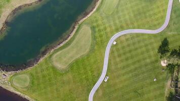 Golf course on a Sunny day, an excellent Golf club with ponds and green grass, view from the sky video