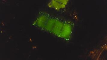 Footbal soccer field night aerial. Clip. Birds eye view of a soccer football court. Top view of the football field at night video