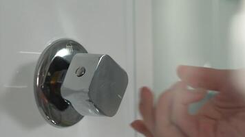 Modern shower cabin with hydro massage. Woman's hand turns the water on in the shower video