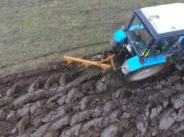 Tractor plowing the garden. Plowing the soil in the garden photo