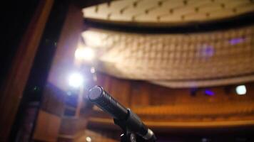 Microphone on the stage and empty hall during the rehearsal. Microphone on stage with stage-lights in the background. Microphone on the stage in the empty hall video