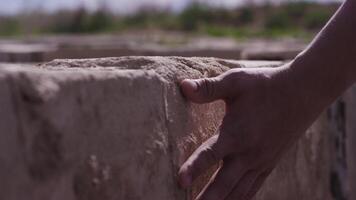 Hand touch stone wall. Hand mans touches the stone wall. Man longing for the native land and places, the concept of the Motherland video