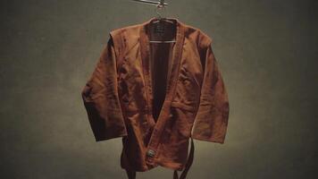 Red kimono for judo. Kimono hanging on the rack. The concept of sport. Memories of childhood video