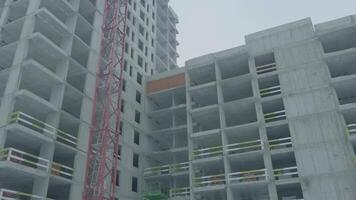 Apartments construction site with crane. Crane and building construction video