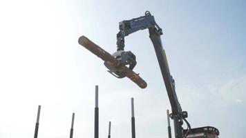 Log loader or forestry machine moves fresh cut logs for loading video