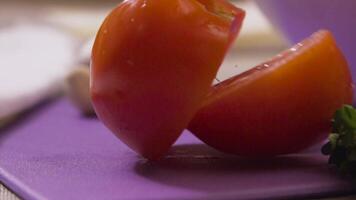 Scheiben von reif Tomate fallen auf das hölzern Tisch. Szene. schleppend Bewegung. Tomate Scheiben fallen auf das Tabelle video