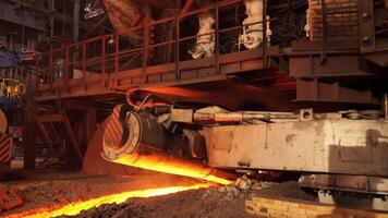 Metallurgical plant, hot metal casting. Machine taphole ramming. Metallurgical equipment video