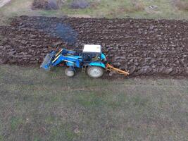 Tractor plowing the garden. Plowing the soil in the garden photo