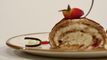 Top view of strawberry cheesecake on wooden table. Piece of chocolate cake with strawberry decorate on top. A piece of moist cheesecake with a fresh strawberry on top and strawberry video